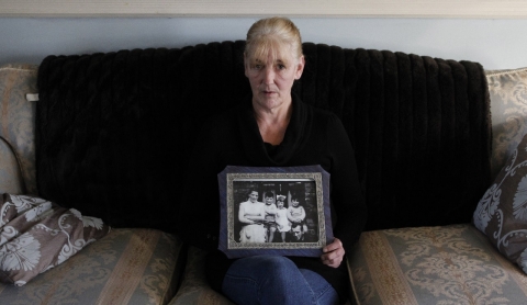 Helen McKendry holds a family photograph showing her mother Jean McConcille, at home in Killyleagh, Northern Ireland.